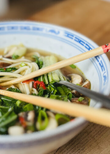 Bowl of mushroom ramen with noodles, pak choi, mushrooms and spring onions"