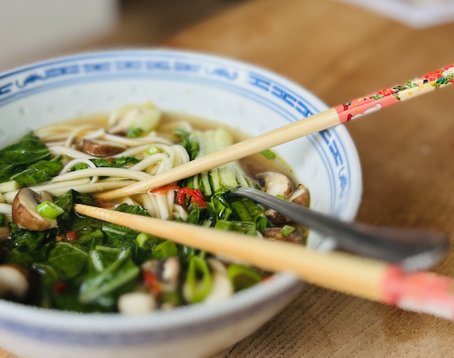 Bowl of mushroom ramen with noodles, pak choi, mushrooms and spring onions"